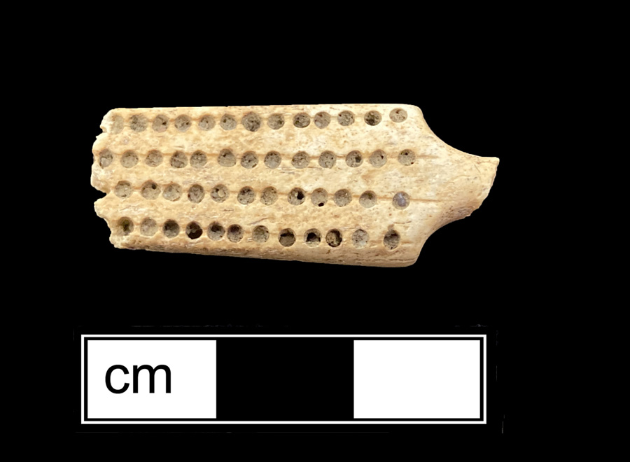Image of bone toothbrush handle, trepanned.