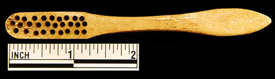 Image of bone toothbrush handle, wire drawn.