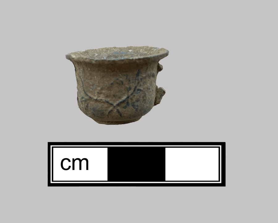 Image of white metal toy cup.