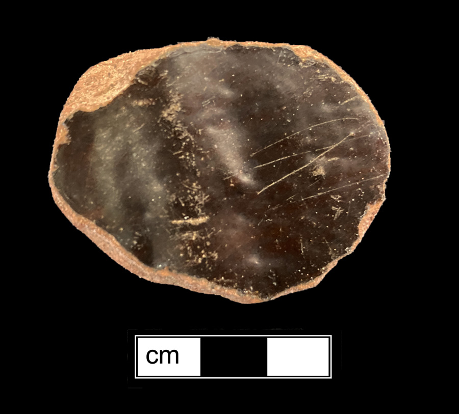 Image of coarse red-bodied earthenware game piece.