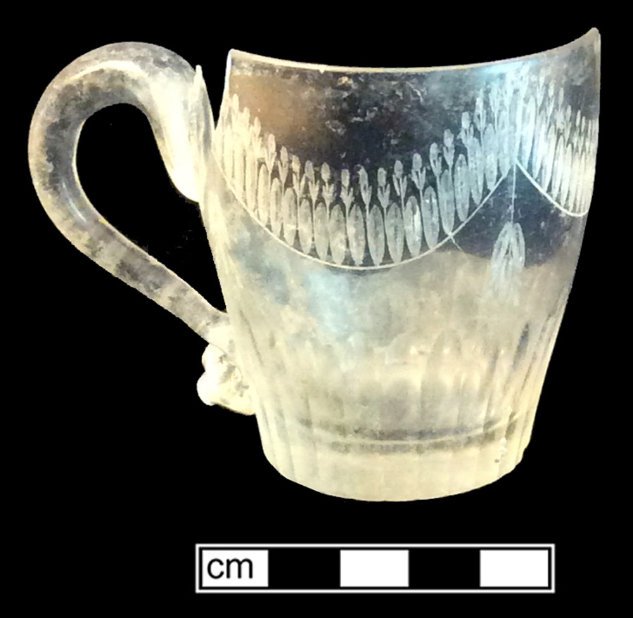 Image of colorless glass mug, glass-on-glass, hot glass decoration.