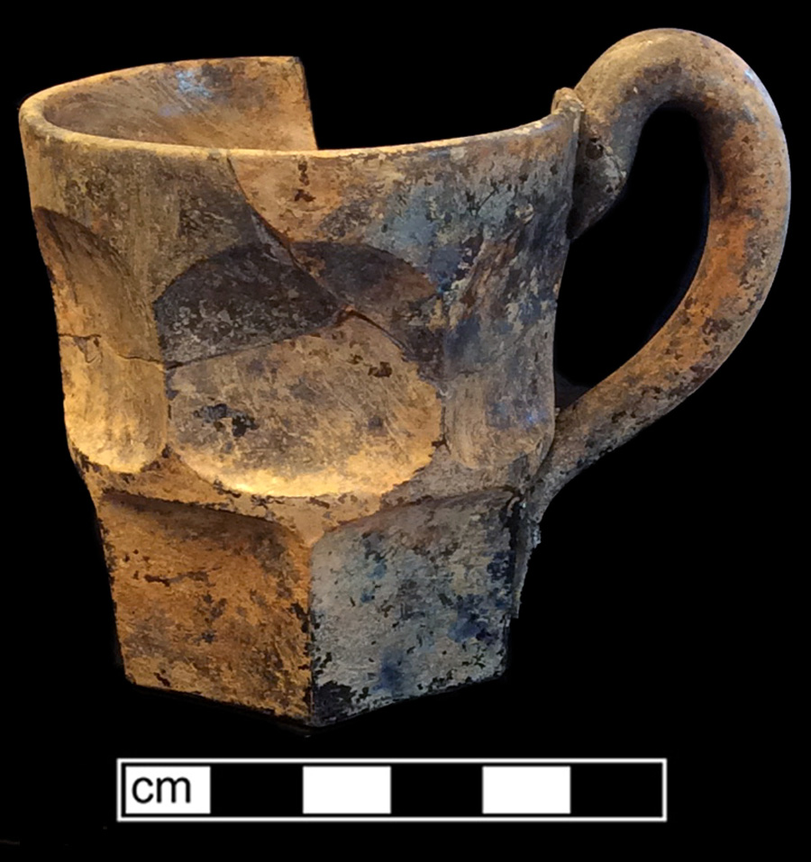 Image of colorless glass mug, glass-on-glass, hot glass decoration.