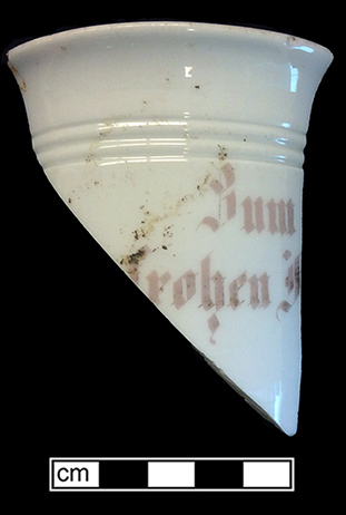 Continental European hard paste porcelain mug with gold luster over pink painted letters. &ldquo;Zum&hellip;Frohen F&hellip;&rdquo; (To a happy F) [Fest?]. Rim diameter: 3.50&rdquo;, Base diameter: 2.75&rdquo;, Vessel height: 3.50&rdquo;. Lot #: 33-1, 2, 3. 18BC56