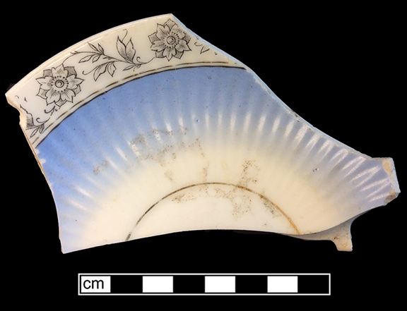 Continental European hard paste porcelain molded saucer with printed overglaze floral rim band, air brushed blue and gold gilt band. Rim diameter: 6.00&rdquo;, Vessel #: 69. 18BC56