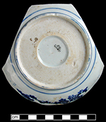 Japanese porcelain pickle dish stencilled underglaze with pine, plum and bamboo central motif.   The use of paper stencils, as seen in the dashed lines around the floral reserves, dates post 1875 (Ross 2012).  “Snake-eye” circular recess on reverse. The use of snake-eye or bulls-eye ends in the 1915 to 1920 period (Ross 2012:15). Dashed lines around floral reserves indicate this design was applied with a stencil.