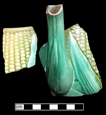 Teapot molded with corn motif. This vessel displays a pink interior glaze.  Lid diameter: 2.50”, Vessel #: 67. 18BC56