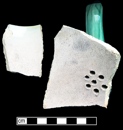 Teapot molded with corn motif. This vessel displays a pink interior glaze.  Lid diameter: 2.50”, Vessel #: 67. 18BC56