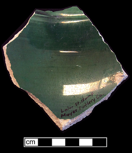 Molded hollow vessel (jug?) with a medallion motif. The interior of this vessel has a green lead glaze.