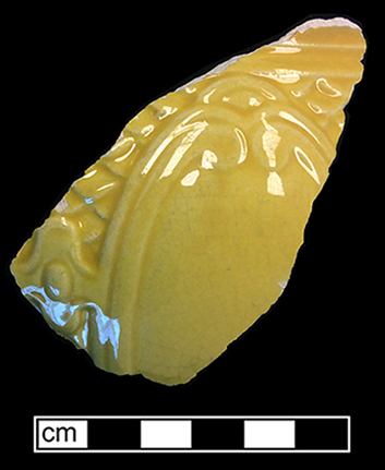 Molded hollow vessel (jug?) with a medallion motif. The interior of this vessel has a yellow lead glaze.