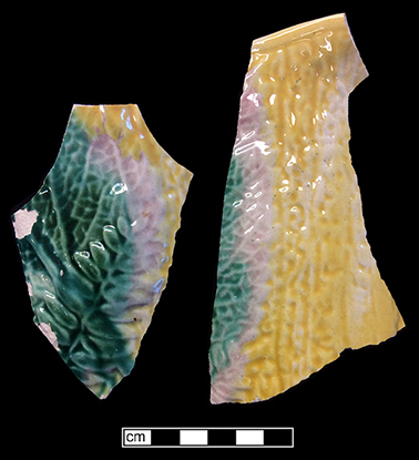 Molded hollow vessel (jug?) with fern motif. The interior of this vessel has a pale green lead glaze.