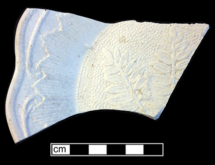 Molded biscuit fired plate with fern motif. Rim diameter: 8.00”. 