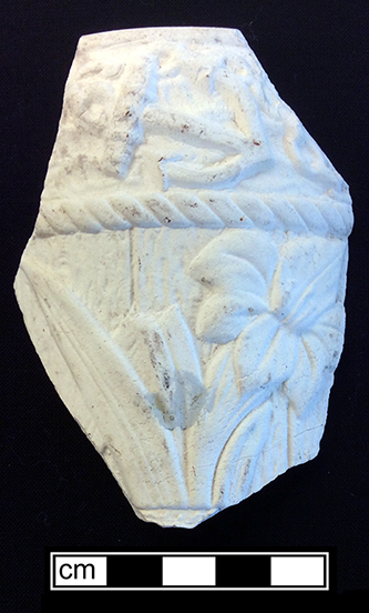 Molded biscuit fired mug with floral and anchor motif. Rim diameter: 3.50”