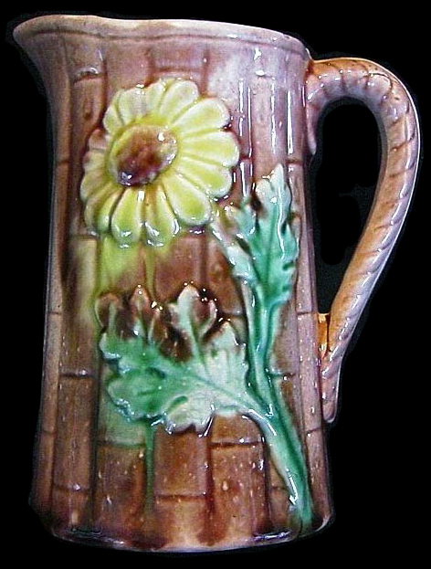 Molded hollow jug with bamboo and leaf motif from http://etruscanmajolica.blogspot.com/2015/04/the-majolica-of-arsenal-pottery.html
