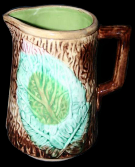 Molded hollow jug with fern motif. The interior of this vessel has a pale green lead glaze - from http://etruscanmajolica.blogspot.com/2015/04/the-majolica-of-arsenal-pottery.html .