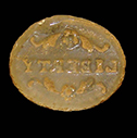 Oval colorless inset with a smooth rounded cabochon top and a back molded with the word “LIBERTY” in reverse so that it would show through the inset. 