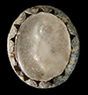 Oval-shaped sleeve link with a scalloped metal edge surrounding a colorless inset molded on the back with the pattern of a single rose. The back of this button is also decorated with a texture like a basket weave spiraling out from the center.