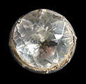 Solid silver sleeve link with a brilliant cut inset that is not made of glass. The lack of decay of the stone suggests that it is colorless quartz which was popularly known in the 17th and 18th centuries as Bristol stone. The cut is slightly asymmetric and the size is small, suggesting likely use as a linked button.