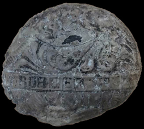 A rubber ball broken in half, with the manufacturer’s name still visible on the center seam. The New York Rubber Company was founded in 1851, but they changed their trade name to Wicapee Rubber in 1859. Because the rubber ball bears the stamp of the New York Rubber Company, that means it was manufactured within that eight year period. 4cm x 3.75cm - from 18BC27.