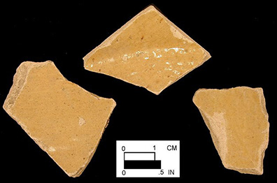 Probable yellow border ware of indeterminate vessel form. Glazed interior base and body sherds from 18CV83.
