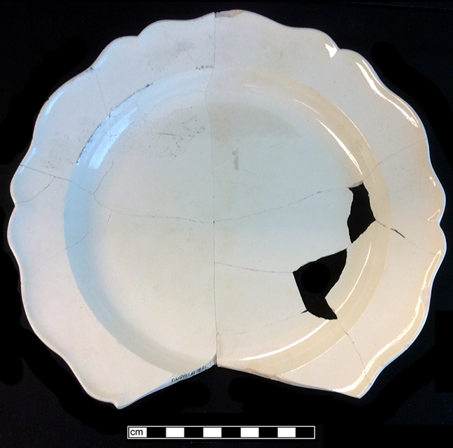 Creamware royal rim plate. Rim diameter: 7.00&rdquo;. Lot: 14, Provenience: 1HA.834.6, Privy Stratum 4. - 18BC38