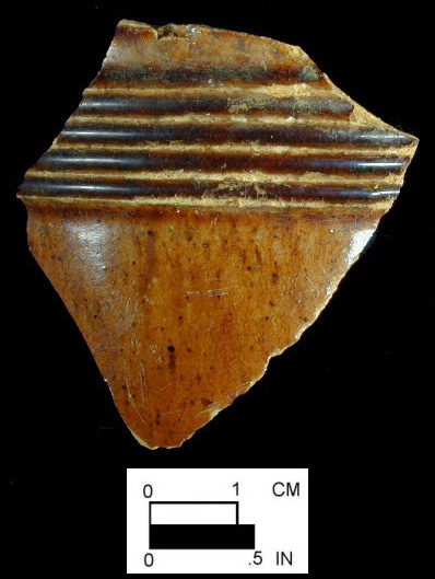 Manganese mottled mug with cordoning and wheel-turned grooves on body, from Gott's Court, site 18AP52-74. This sherd was recovered from sheet midden associated with the John Golder family, circa 1760-1795.