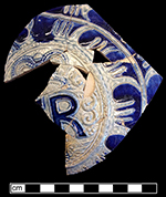 Gray-bodied salt glazed stoneware jug with applied round medallion molded with crowned GR cipher of King George I (1714-1727) or King George II (1727-1760). Incised with scroll-like motifs outlined in cobalt-blue, from 18CV60. 