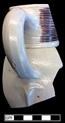 Gray-bodied salt glazed stoneware jug with concentric rilling with manganese decoration under the glaze.   Terminus of the strap handle is known as rat tail.   Lug hole at the top of the handle indicates the vessel once had a pewter or brass lid from 18CV60 Angelica Knoll.