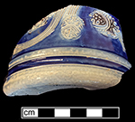 Gray-bodied salt glazed stoneware straight-sided tankard with applied blossoms and engraved stems painted under the glaze in cobalt-blue and manganese. 4.0&rdquo; base diameter, from 18CV60.