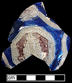 Gray-bodied salt glazed stoneware jug with applied  floral motifs and applied octagonal medallion of King William III (1689-1702).  Cobalt-blue and manganese under the glaze. Vessel dates to the reign of King William III. From 18CV60. 