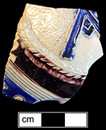 Gray-bodied salt glazed stoneware jug  with applied AR medallion and engraved (incised) motifs outlined in cobalt-blue  and manganese under the glaze from 18DO58. This medallion stands for British monarch Queen Anne (1702-1714).  