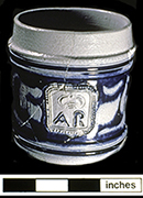 Gray-bodied salt glazed stoneware straight-sided tankard  with applied AR medallion and engraved (incised) foliage outlined in cobalt-blue under the glaze. Cordoned rim. This medallion stands for British monarch Queen Anne (1702-1714).  Vessel date 1702-1714, from 44YO205 John Bates Site. Photo courtesy of the Colonial Williamsburg Foundation.&nbsp;Artifacts from private collection.