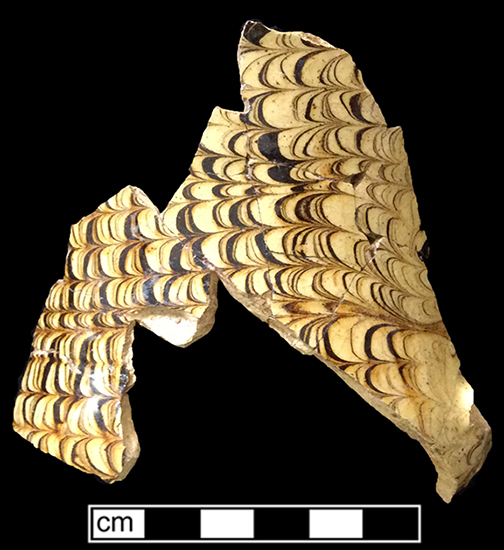 North Midlands slipped earthenware handled cup/mug with combed brown slip on white slip ground, from 18KE292.