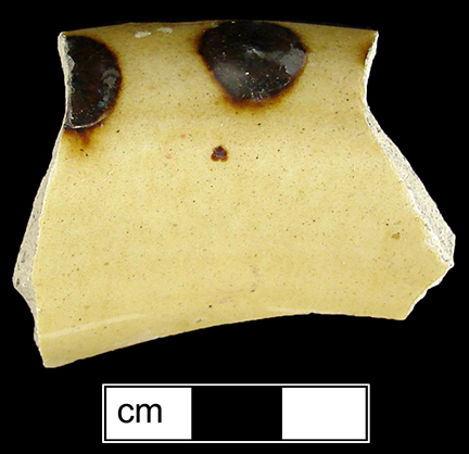 North Midlands combed and dotted slipware hollow vessel (bowl or chamberpot?).  Glazed interior and exterior, rim diameter is 5" - Collected by George L. Miller in 1986 in Staffordshire, England.