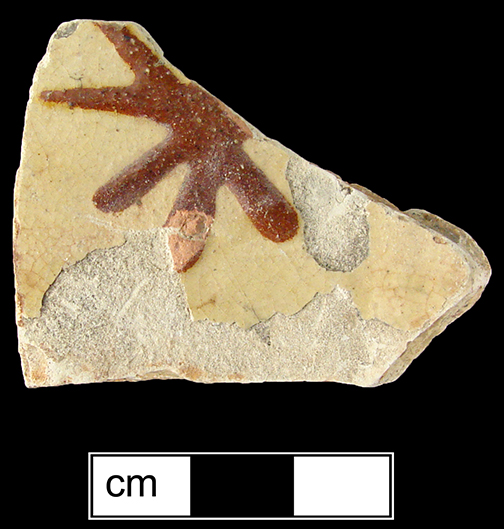 North Midlands slip decorated hollow vessel of indeterminate form. Decorated in asterisk pattern in red slip. Glazed interior and exterior - Collected by George L. Miller in 1986 in Staffordshire, England.