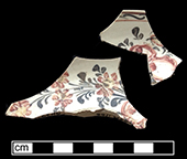 Saucer painted overglaze in floral motif in red, yellow and brown from 18AN39.