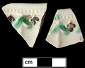 Molded rim plate with painted underglaze accents in green and brown. Underglaze painting began to be used in the 1770s (Barker and Halfpenny 1990:71).  