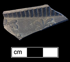 Dry-bodied black basalt hollow vessel with spring-molded decoration. Lot: 1017-18. 18BC62