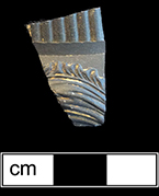 Dry-bodied black basalt hollow vessel with  sprig molded decoration.  Glazed interior. Minimum Vessel 6029. Lot: 1394. 18PR175.