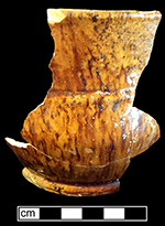 Manganese mottled “thistle” shaped cup (flared neck and compressed spherical body). A similarly shaped cup depicted in Williams (2003:121) was dated c. 1700-1720. Rim diameter: 5.5”, Base diameter: 3.5”, Vessel height: 4.0”. Peter Williams 2003. The Talbot Hotel Pit Group. Ceramics in America. Edited by Robert Hunter. Chipstone Foundation, pp. 111-138.