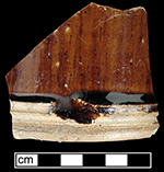 Manganese Mottled mug or tankard with cordoning at the foot band. A break in the cordoning allowed the body glaze to run onto the unglazed cordoned area. The foot and base of the vessel are unglazed - collected by George L. Miller in 1986 in Staffordshire in Hanley. Cannot be attributed to a specific pottery.
