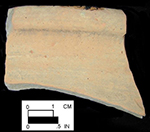 North Devon Gravel-free Coarse Earthenware Hollow (probable pan). Lead glazed interior (left); unglazed exterior (right), approximately 10&ldquo; rim diameter. Damage to the left side of the sherd reveals the grey inner core caused by oxygen reduction during firing. Square 2855.