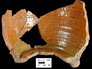 North Devon Gravel-Tempered Coarse Earthenware Pipkin. Unglazed exterior and glazed interior, 3 legged. While this site is conservatively dated c. 1660-1700, it is likely the assemblage represents the household of Henry Hosier, merchant, who occupied the site c. 1671-1686.