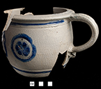 Gray-bodied salt glazed stoneware chamberpot  with applied rampant lion and stamped rosettes outlined in cobalt-blue  under the glaze.  Cordoned rim and base. Rim diameter. 6.70&rdquo;; Base diameter: 5.50&rdquo;; Vessel height:  5.75&rdquo;; Object ID: 2602.