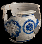 Gray-bodied salt glazed stoneware chamberpot  with applied rampant lion and stamped rosettes outlined in cobalt-blue  under the glaze.  Cordoned rim and base. Rim diameter. 6.70&rdquo;; Base diameter: 5.50&rdquo;; Vessel height:  5.75&rdquo;; Object ID: 2602.