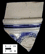 Gray-bodied salt glaze stoneware straight sided tankard with applied floral motif and engraved (incised) motif with cobalt-blue painted decoration under the glaze. Cordoned below rim. 4.25&rdquo; rim diameter, from 18CV60.