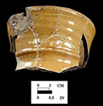 North Devon jug.  Possibly plain slip-coated variety. 2.75&rdquo; rim diameter. White slip over red and grey earthenware body, with lead glazed exterior.