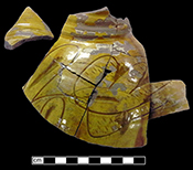 North Devon sgraffito jug with incised floral motif. White slip over red and grey earthenware body, with lead glazed exterior-QV78.