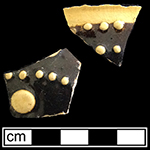 North Midlands slip decorated hollow vessel of indeterminate form.  Exterior decorated with “jeweled” dots of slip typical of late 17th- and early 18th-century vessels.  Decorated in white and brown slip. Glazed interior and exterior.  Lot 147.