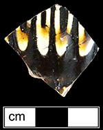 North Midlands reverse slip decorated hollow vessel of indeterminate form. Vessel covered with brown slip, with white slip trailed decoration applied over brown slip on vessel exterior - Collected by George L. Miller in 1986 in Staffordshire, England.