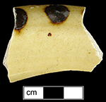 North Midlands combed and dotted slipware hollow vessel (bowl or chamberpot?).  Glazed interior and exterior, rim diameter is 5" - Collected by George L. Miller in 1986 in Staffordshire, England.